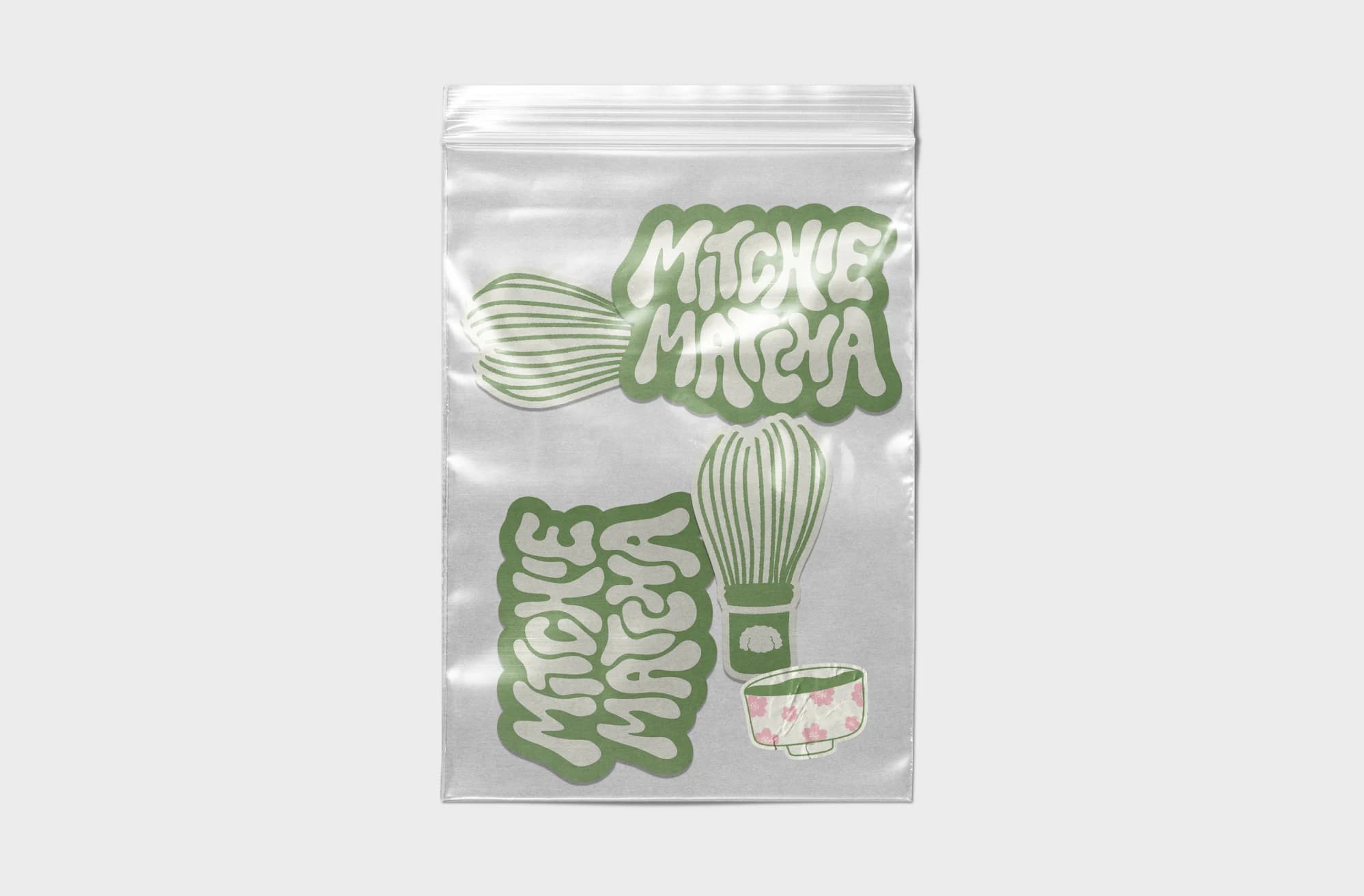 Clear bag of Mitchie Matcha stickers: green bubble-letter logos and a matcha whisk