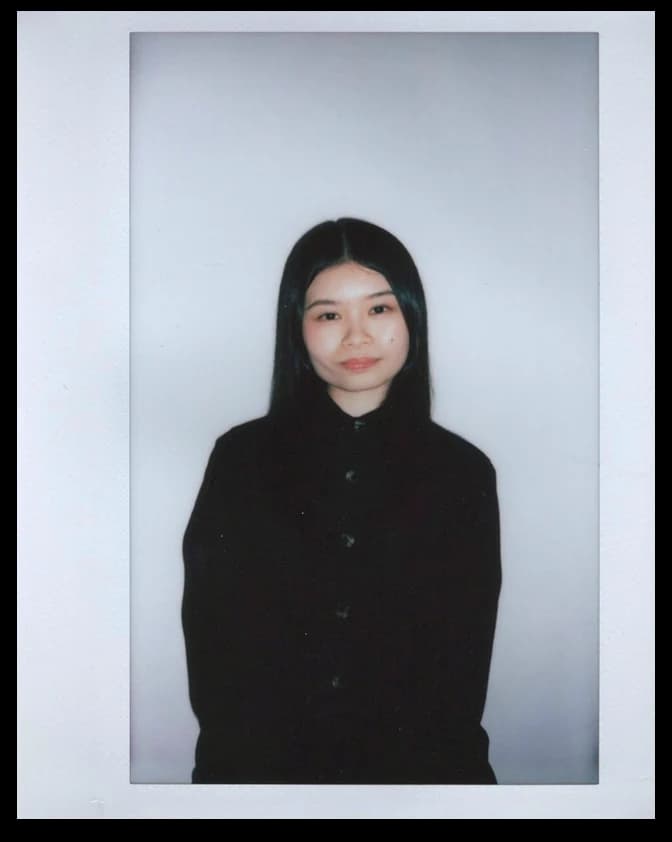 Portrait of Rose in a black shirt against a light grey backdrop